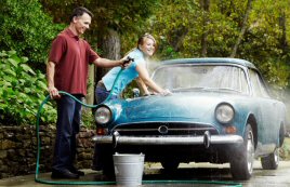 Man and woman washing car.